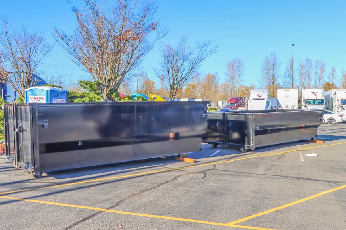 Professional dumpster rental service with roll-off container on residential driveway in Sandersville